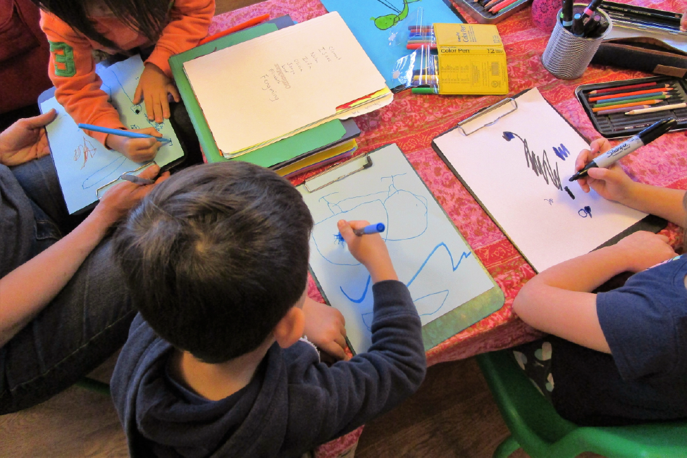 Children in classroom drawing together